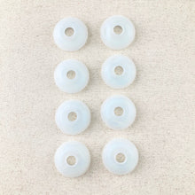 Load image into Gallery viewer, Eight weighted bobbins shown in the closed position with the plastic side up.
